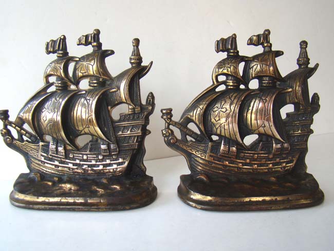 A pair of antique bookends inscribed "A Galleon of the time of Elizabeth 1558-1603" by A.M. Greenblat Studios, Boston, 1925.